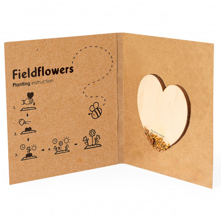 Coração de sementes de flores silvestres em madeira natural